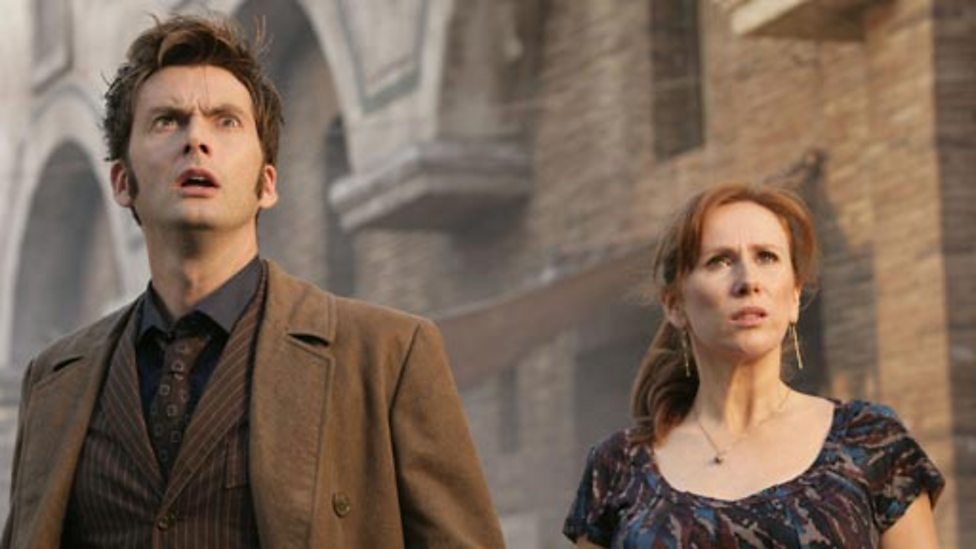 The Tenth Doctor and Donna Noble in Pompeii, watching as the volcano begins to erupt.